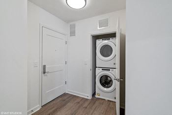 a white laundry room with a washer and dryer in it
